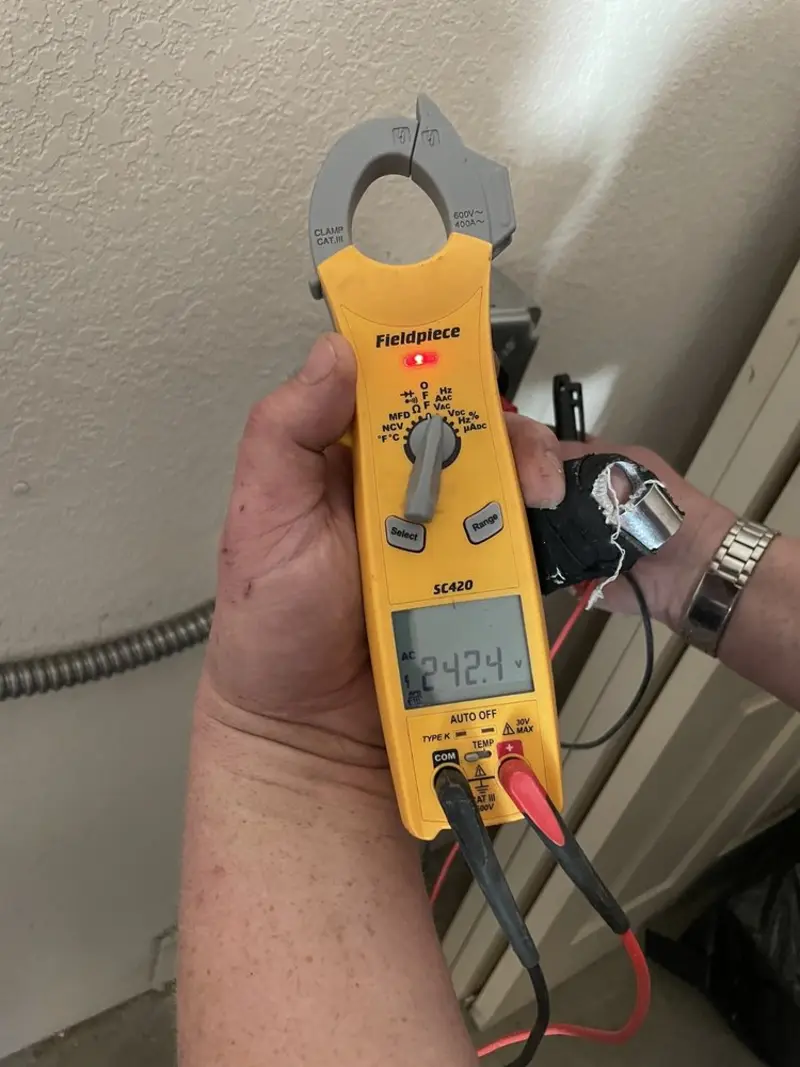 Voltage testing with clamp meter during Recessed Lighting Installation in Kennesaw